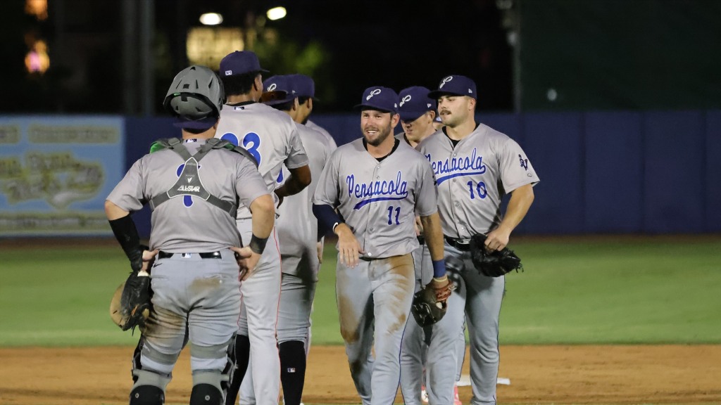 The Blue Wahoos celebrate after securing their 11-10, 10-inning win over the Shuckers on Thursday.