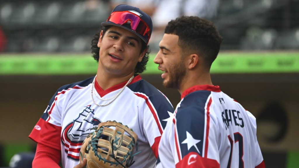 Clippers top prospect Ralphy Velazquez chats with Blue Jackets goaltender Jet Greaves prior to Friday night's game against Iowa