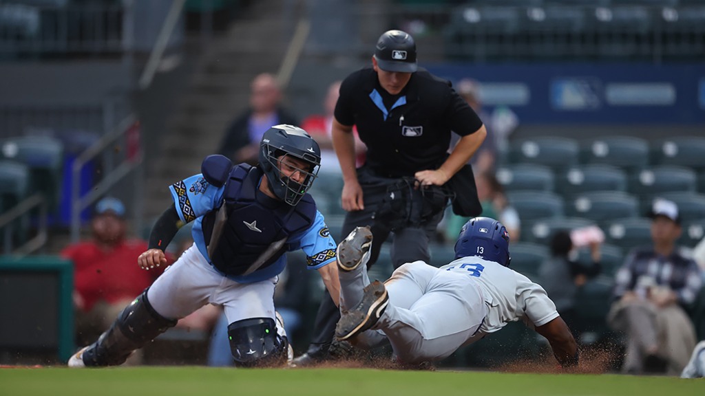 Zyhir Hope slides home safely during Tulsa's 11-7 loss in Arkansas on Tuesday night.