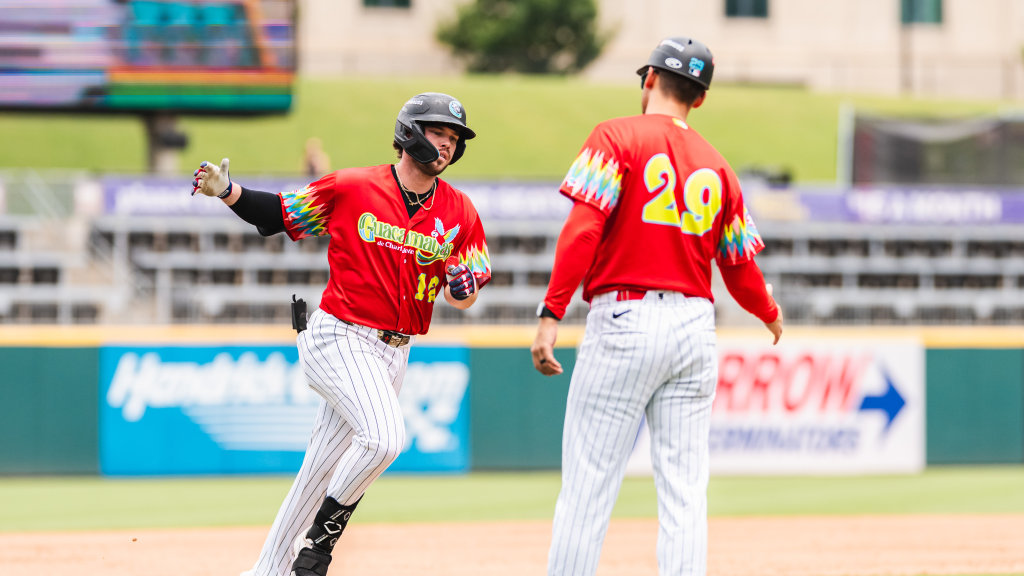Knights catcher Michael Turner is congratulated by manager Chad Pinder after hitting a Grand Slam in the fourth inning.