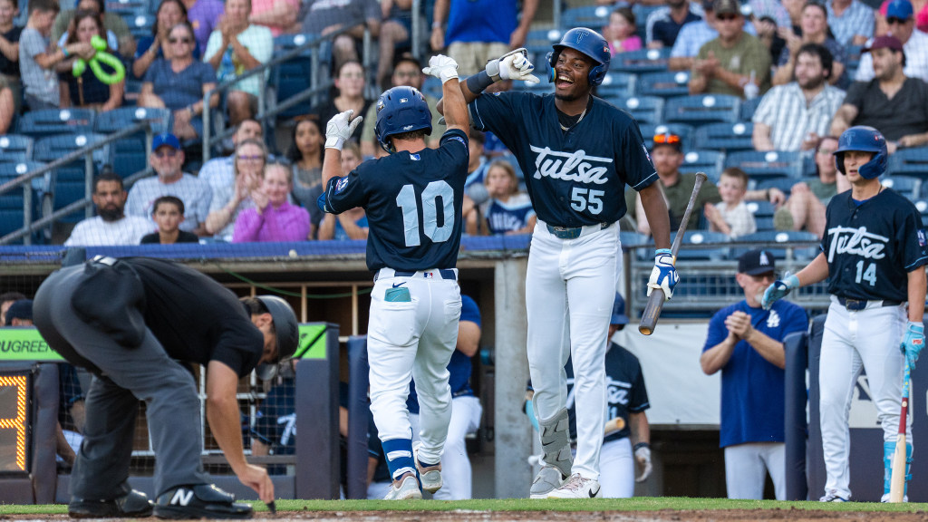 Taylor Young is congratulated by Josue De Paula following his leadoff home run in the first inning.