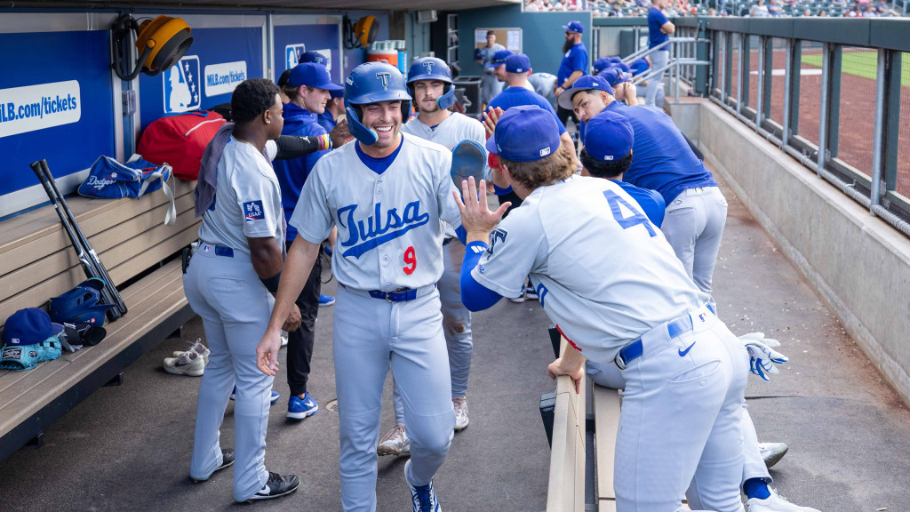 Chris Newell receives congratulations from his teammates during Tulsa's win in Wichita on Tuesday night.