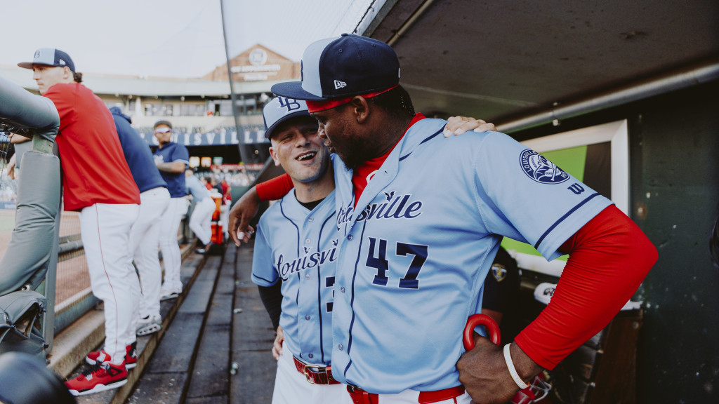 Anthony Misiewicz shares a moment with Luis Mey in the dugout.