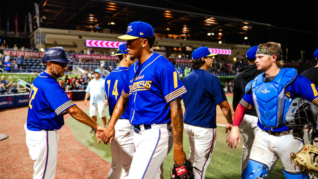Blue Wahoos manager Nelson Prada greets players after May 20 win against Columbus Clingstones.