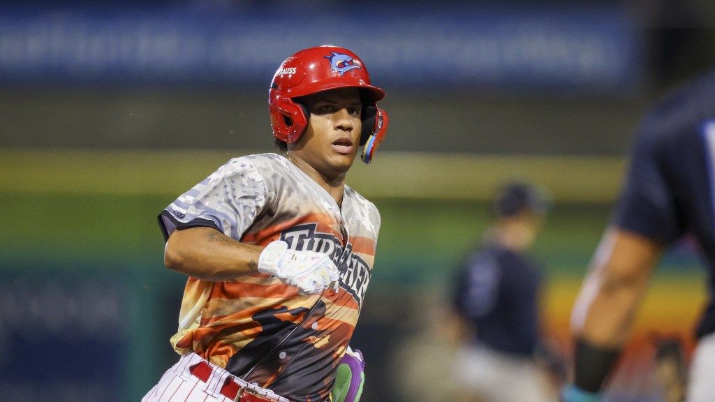 Phillies outfield prospect Victor Cardoza legs out a base hit for the Clearwater Threshers at BayCare Ballpark.
