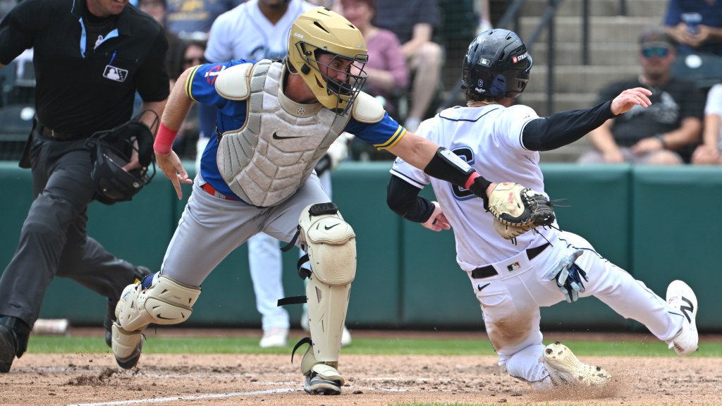 Kody Huff slides in safely past the tag to score for Columbus in the 6th inning Sunday