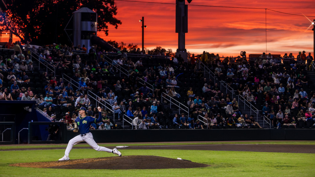 Joe Adametz pitches under a sunset at Fifth Third Park.