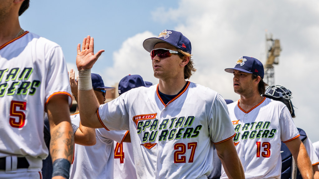 Maxton Martin high-fives his teammates after a win.