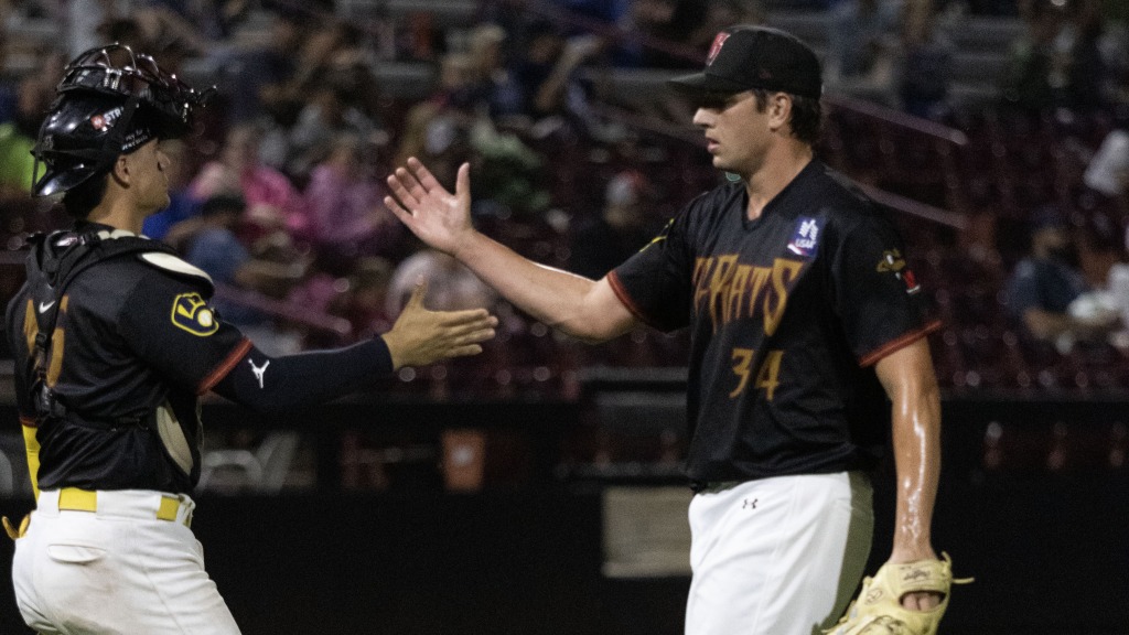 Blayberg Diaz (L) and Jacob Morrison (R) congratulate each other after the final out of Wisconsin's 6-4 win in game two of Saturday's doubleheader at Neuroscience Group Field on August 1.