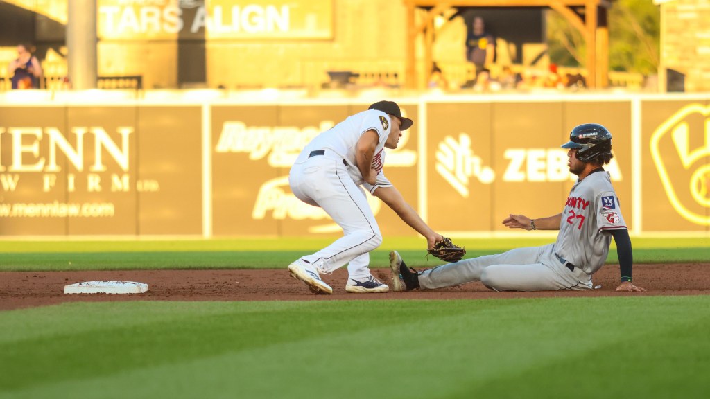 Brady Ebel applies the tag on Jose Pirela on a stolen base attempt in the top of the third inning on August 22.
