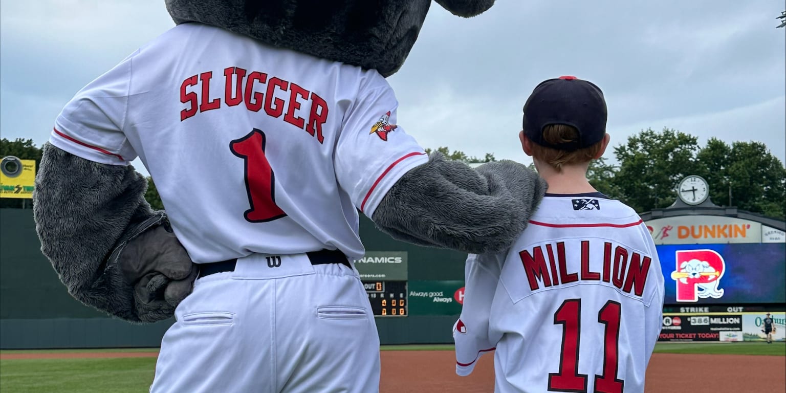 Portland Sea Dogs mascot, Slugger, races a young fan around the