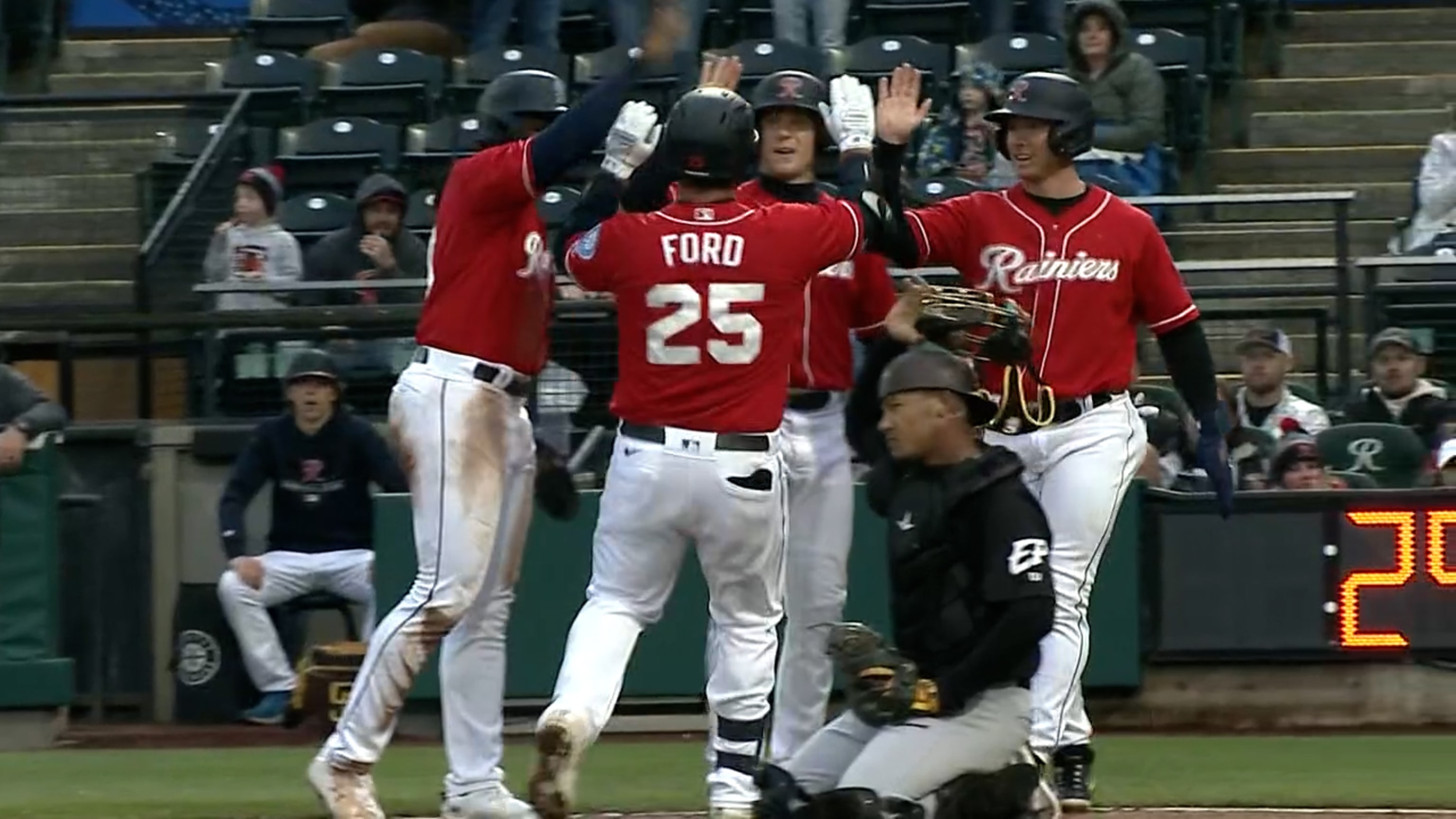 Seattle Mariners' Mike Ford walks in the dugout after striking out