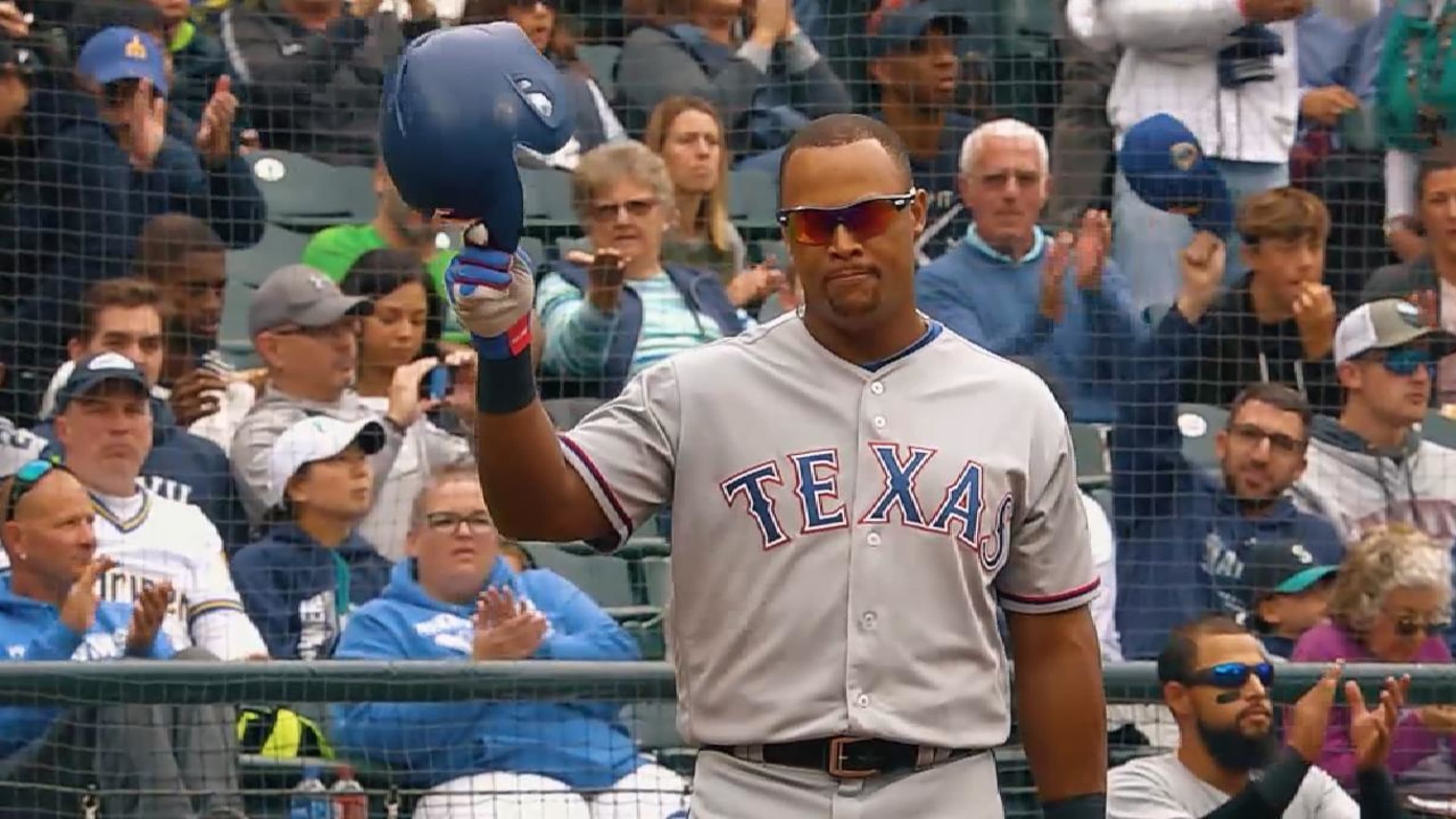 Retired Texas Rangers player Adrian Beltre, left, is presented with a gift  by shortstop Elvis Andrus from the team during a jersey retirement ceremony  for him before the second baseball game of