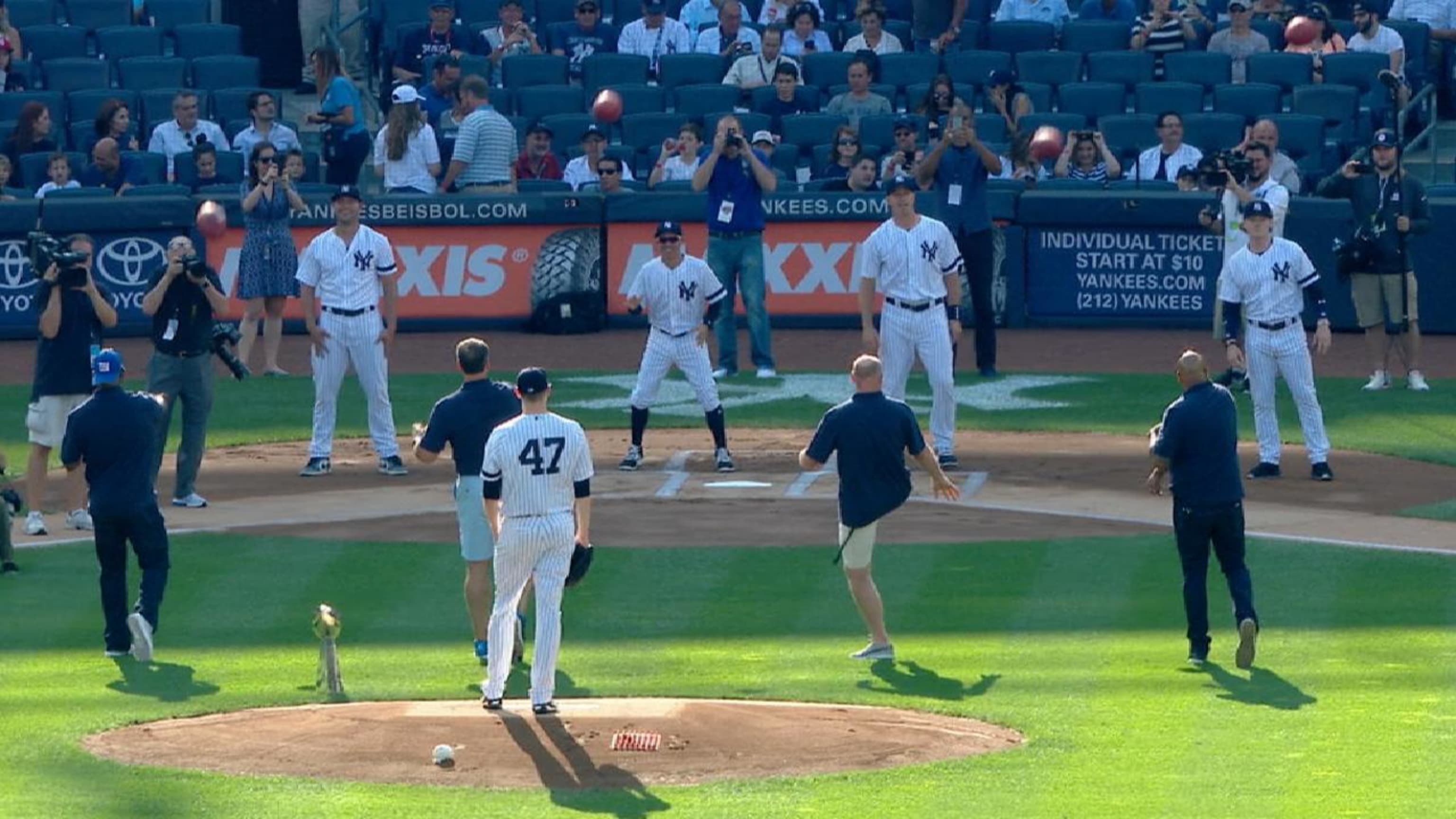 Members of the 2007 New York Giants threw (and kicked) ceremonial first  passes at Yankee Stadium