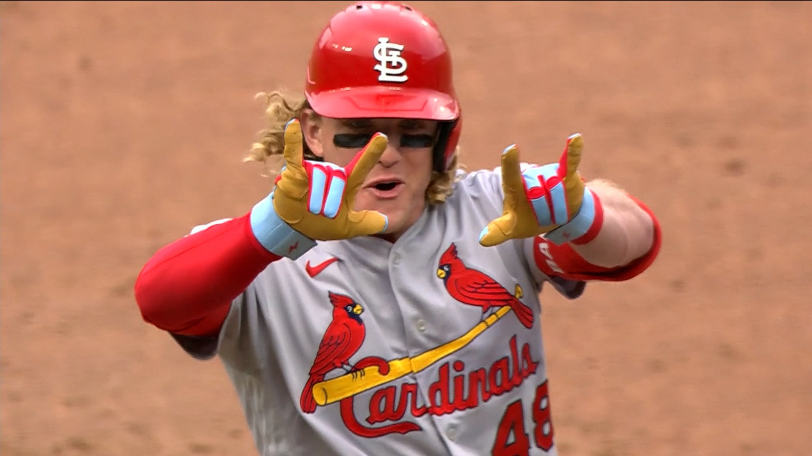 St. Louis Cardinals Harrison Bader removes his batting gloves