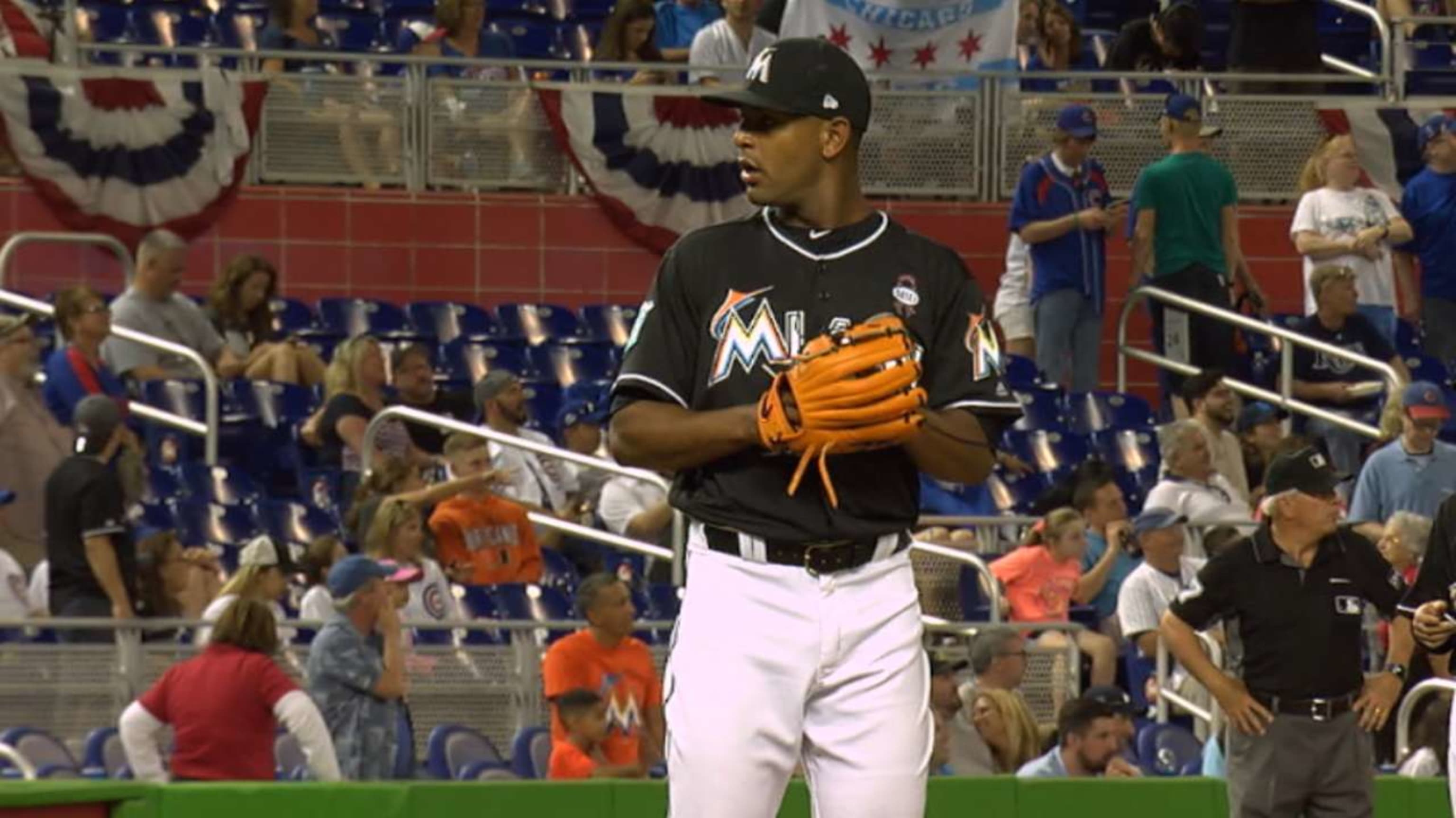 Miami Marlins' Miguel Rojas, wearing a mask, and Derek Dietrich