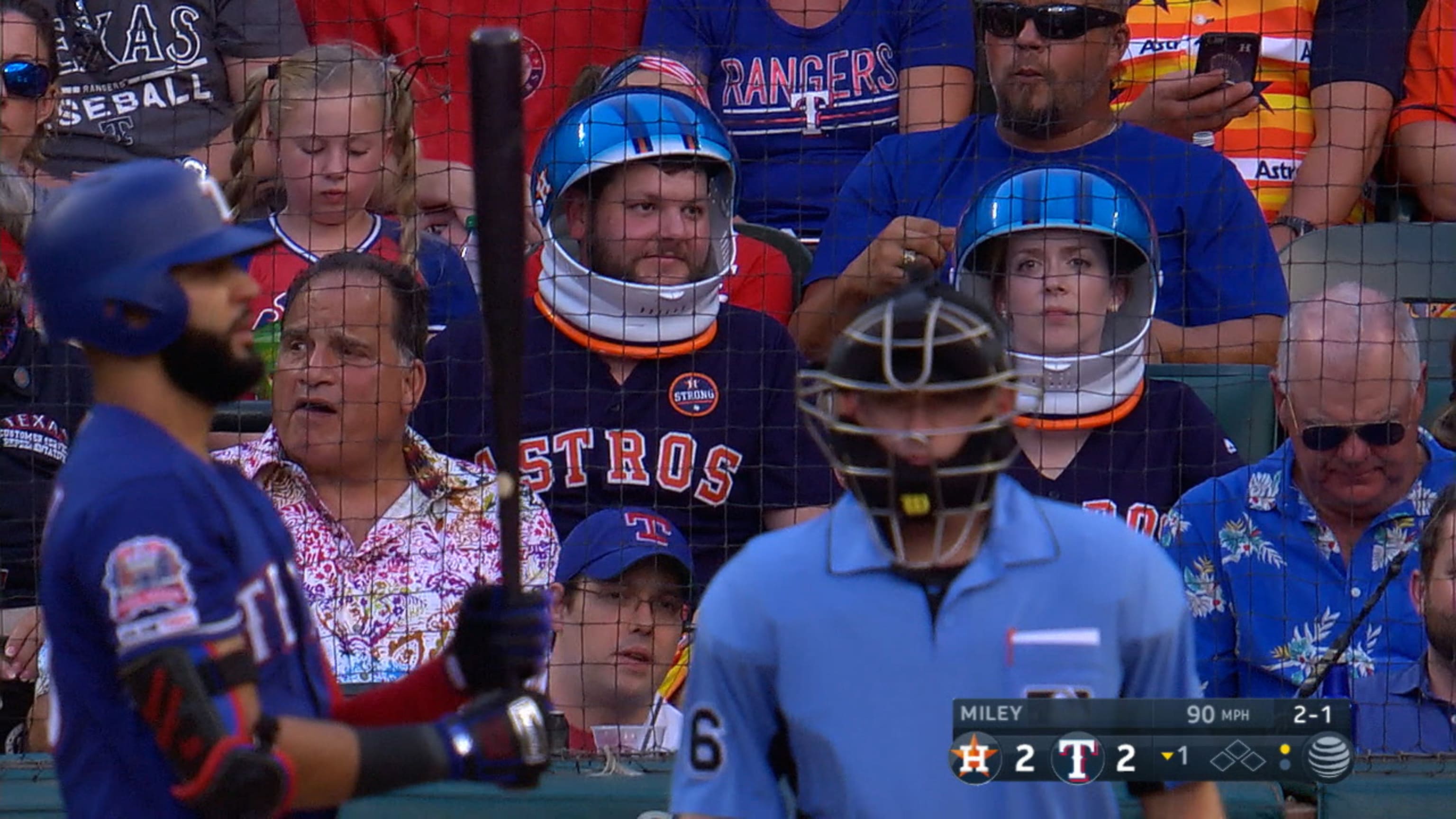 Astros fans wear space helmets behind the plate