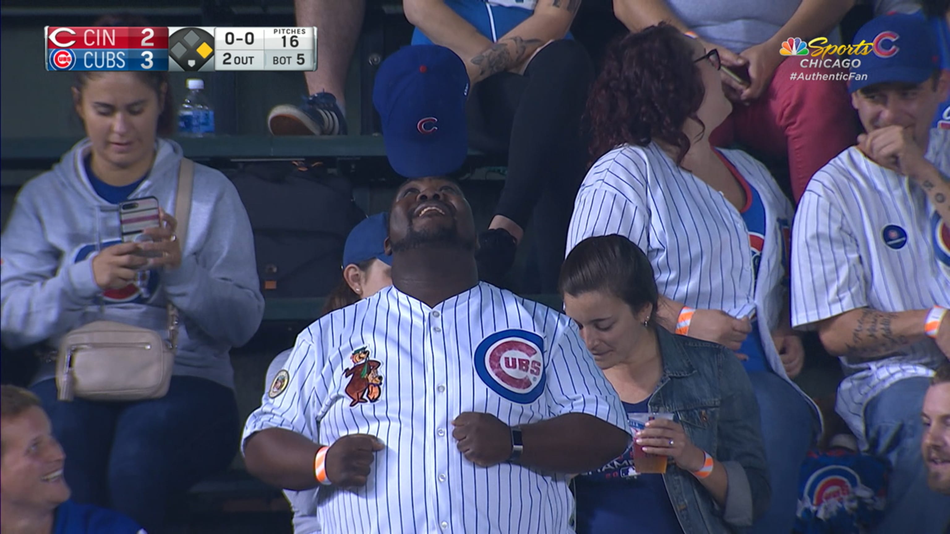 Cubs fan balances hat brim on head