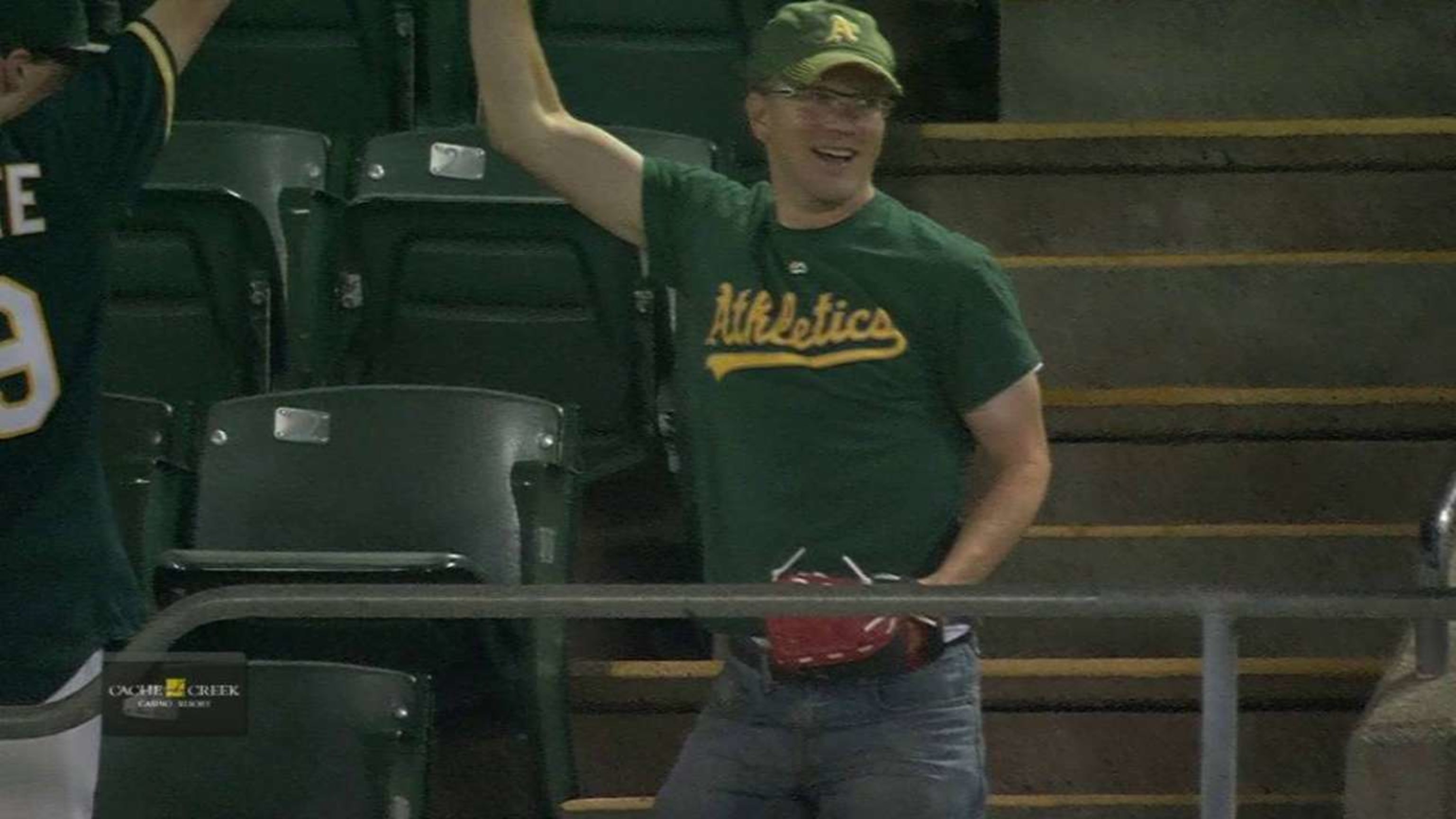 An A's fan dad used his kid's glove to make a leaping grab on a