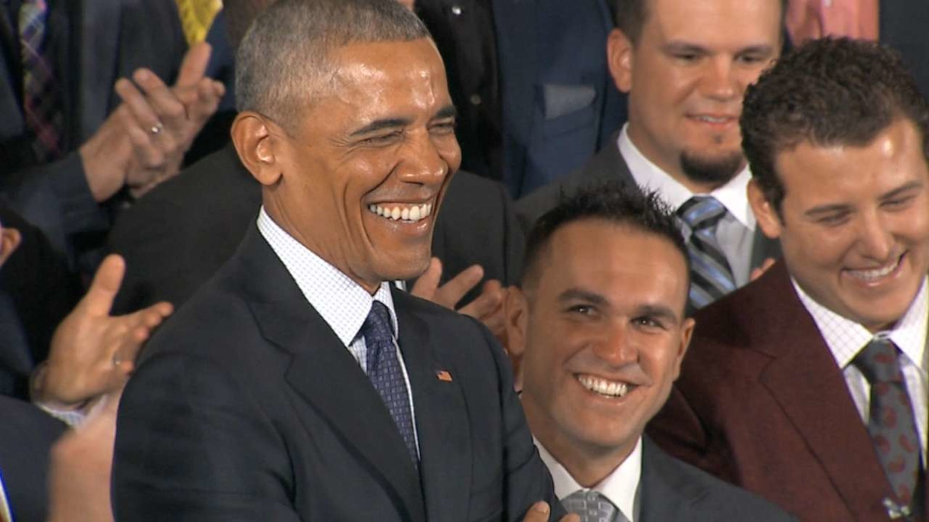 President Barack Obama smiles as Chicago Cubs first baseman Anthony Rizzo  presents him with a 'Chicago' jersey during a ceremony to honor the Cubs in  the East Room of the White House