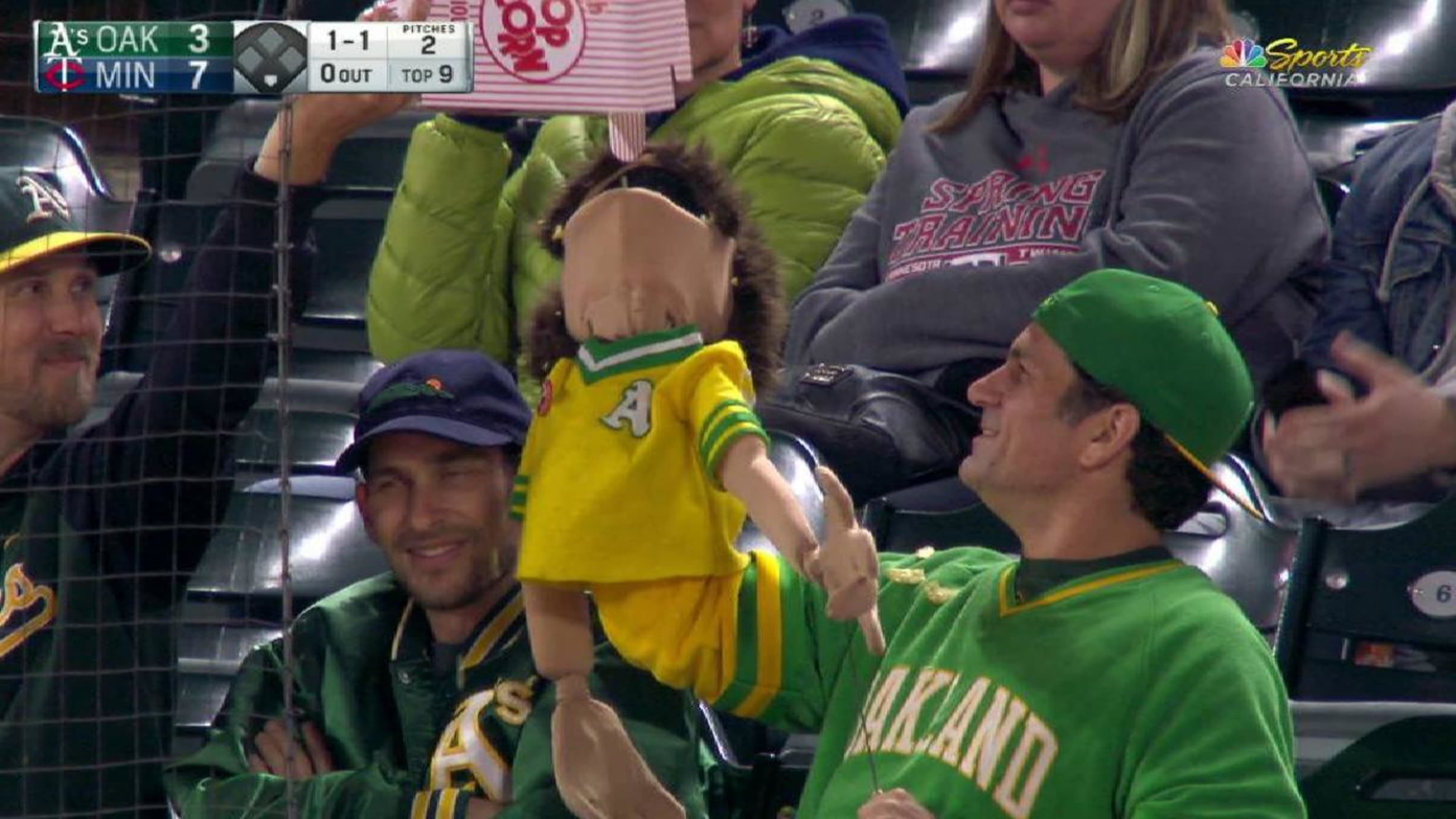 A's fan has fun with puppet in the stands 