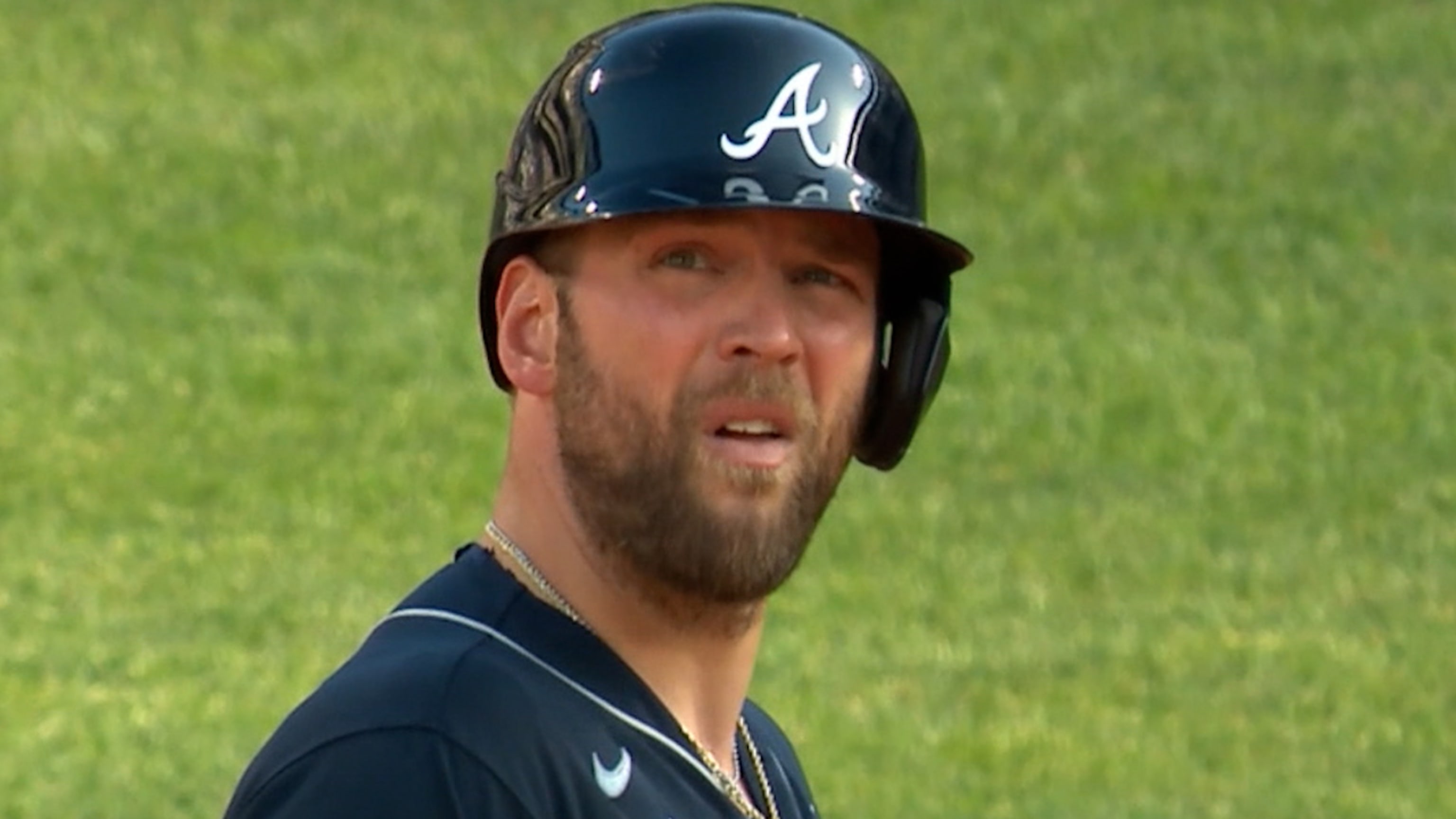 Joc Pederson of the Atlanta Braves puts a batting helmet over his