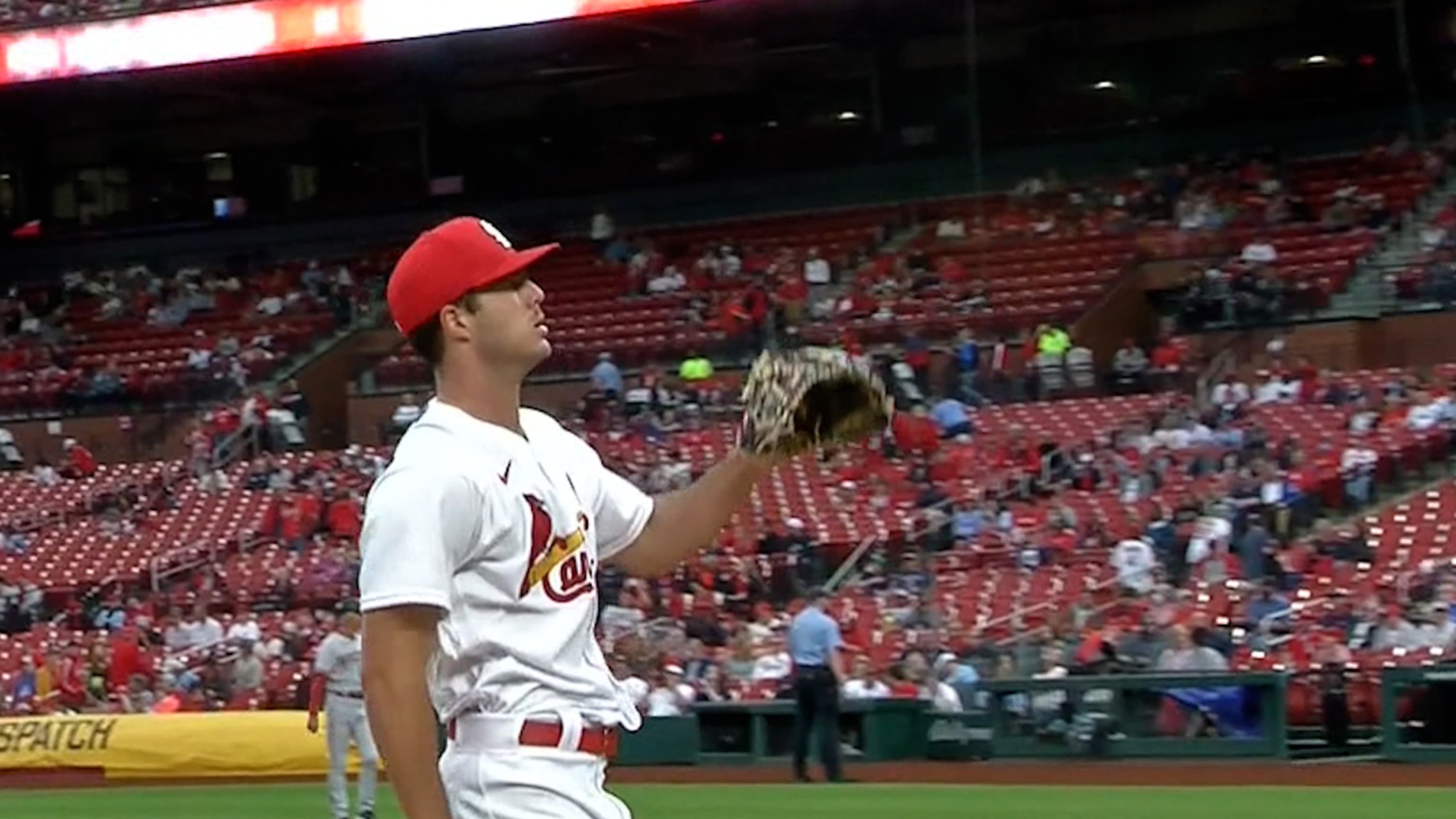 St. Louis Cardinals Harrison Bader removes his batting gloves