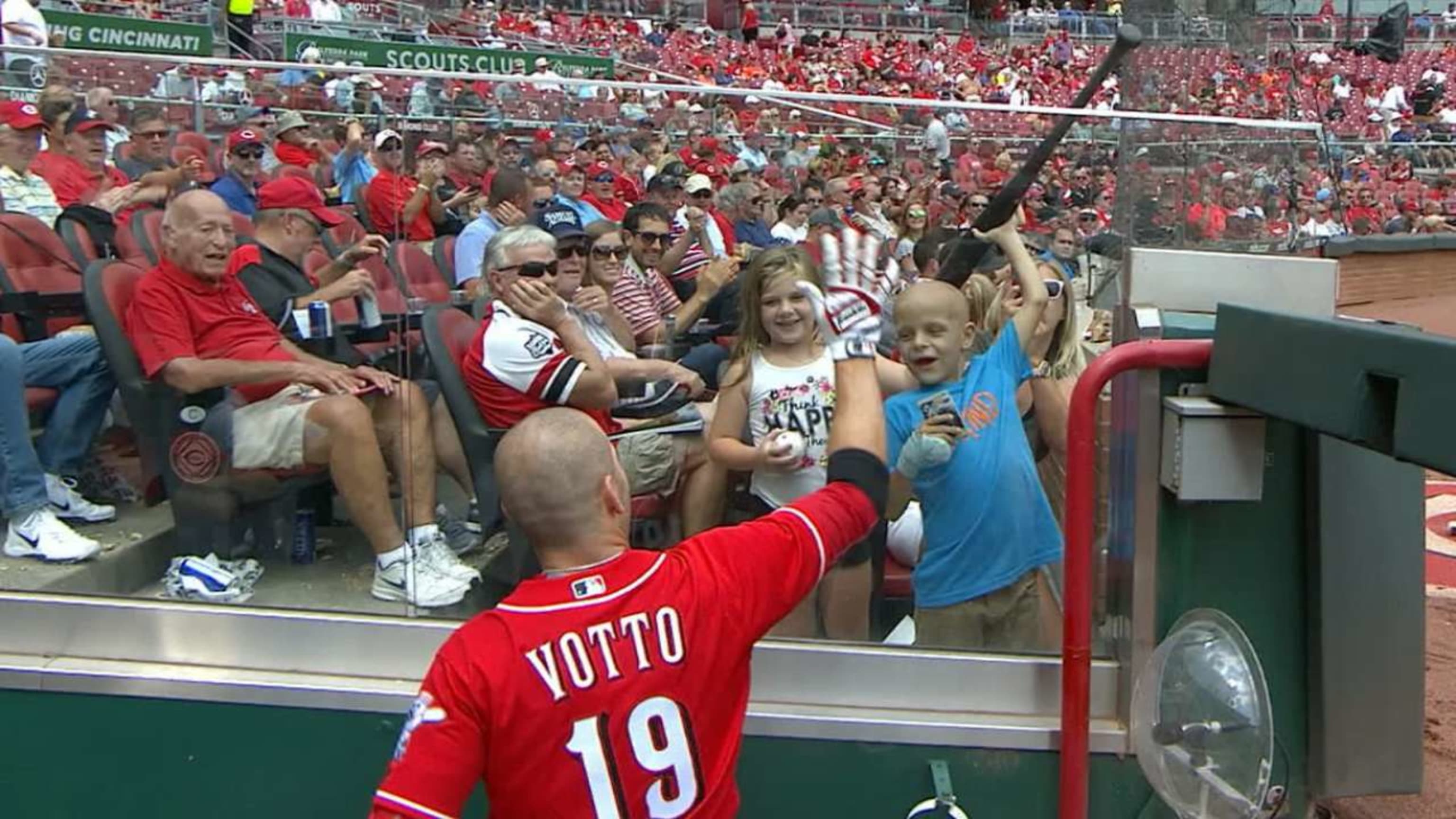 After hitting a home run, Joey Votto gave his bat and jersey to a