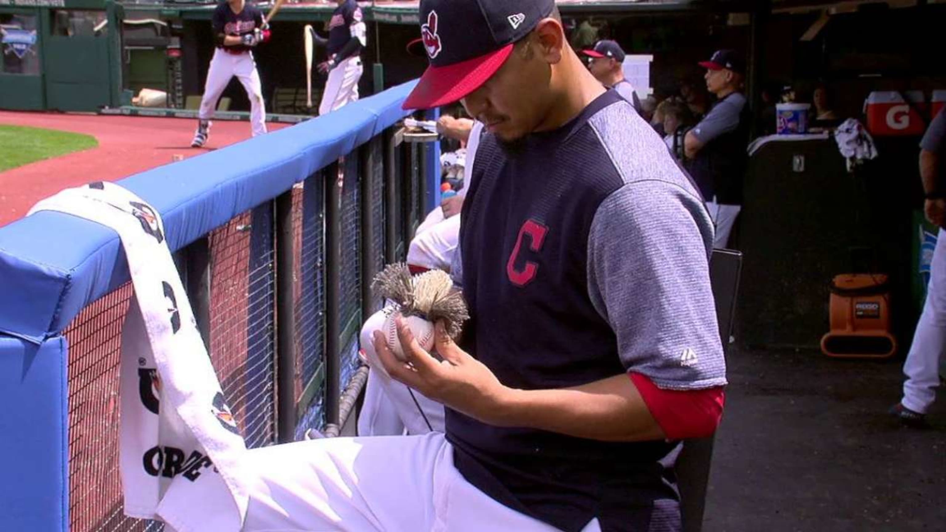 Cleveland Indians Jose Ramirez holds up a 'Mini Jose' baseball, made by  Carlos Carrasco and Tr…