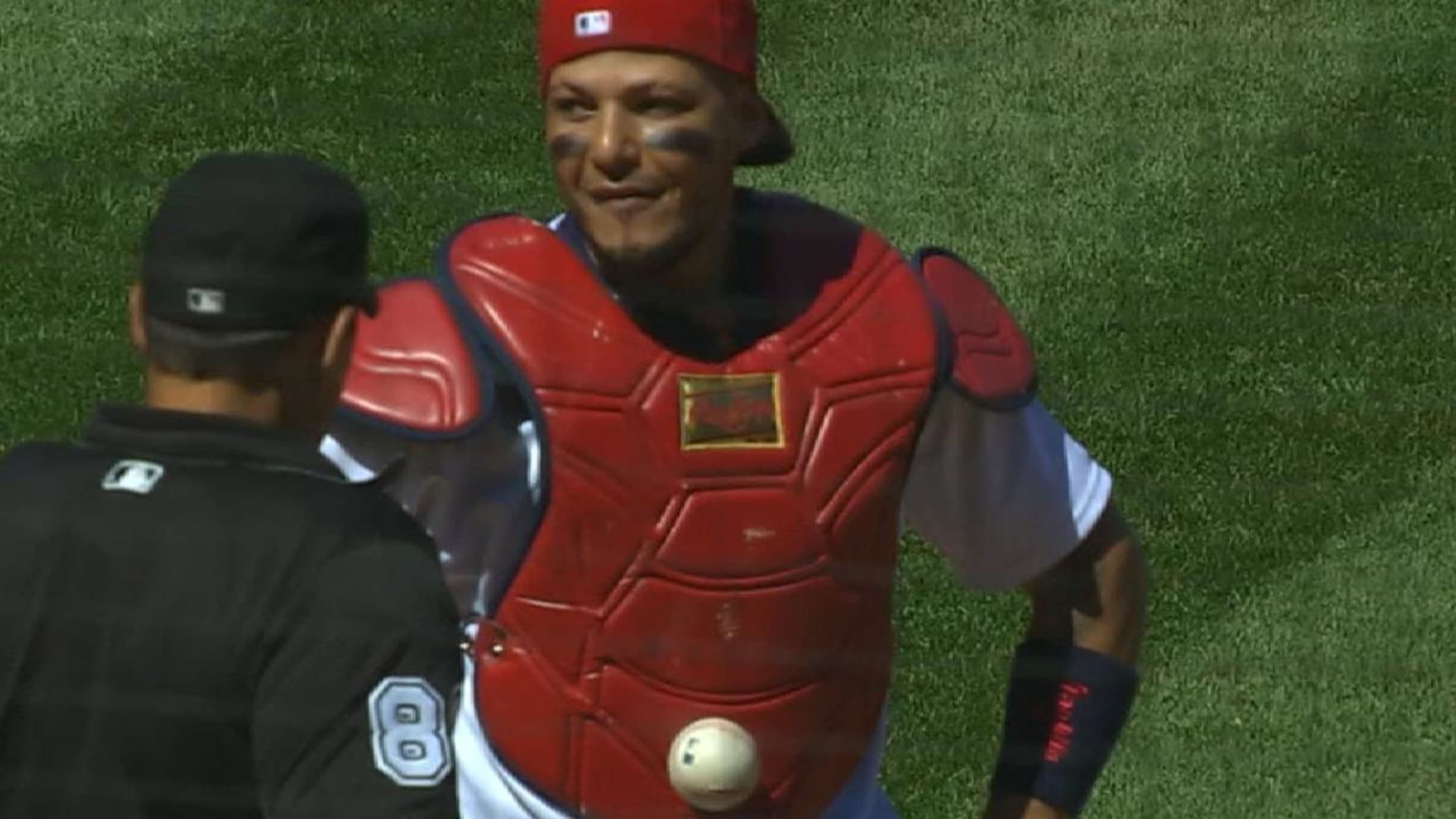 A baseball wedged itself in Yadier Molina's chest protector