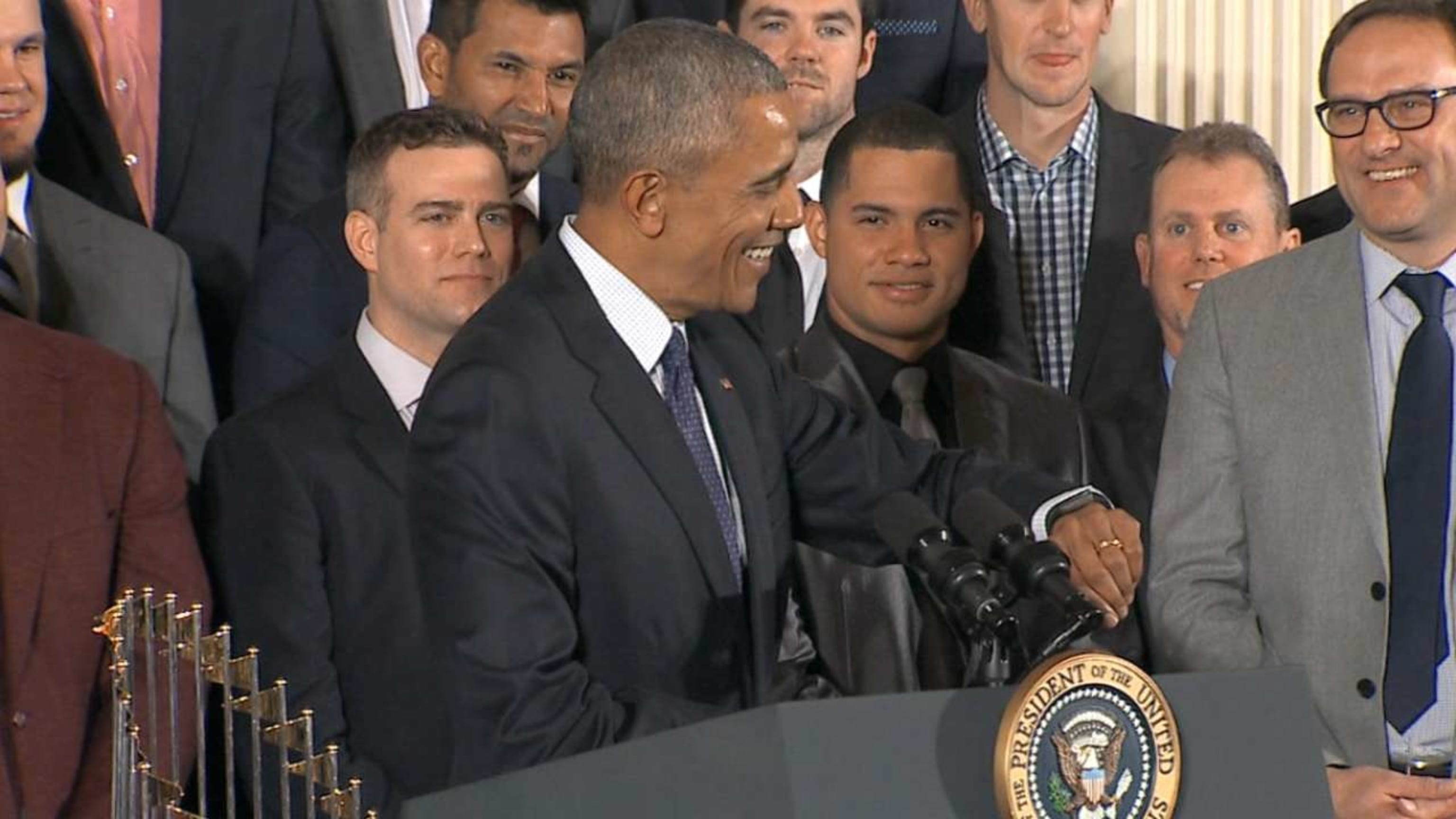 President Barack Obama smiles as Chicago Cubs first baseman Anthony Rizzo  presents him with a 'Chicago' jersey during a ceremony to honor the Cubs in  the East Room of the White House