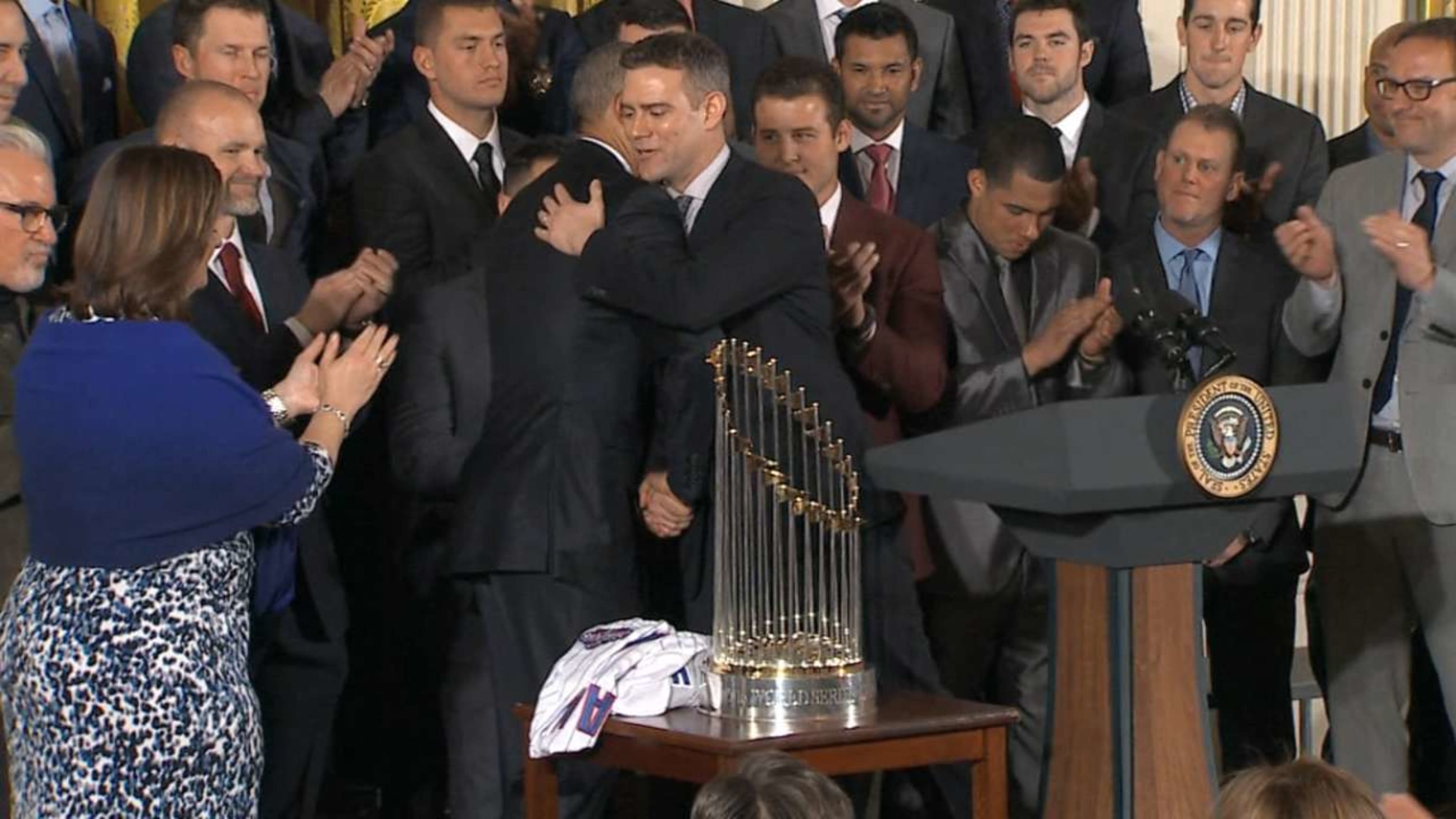 President Barack Obama smiles as Chicago Cubs first baseman Anthony Rizzo  presents him with a 'Chicago' jersey during a ceremony to honor the Cubs in  the East Room of the White House