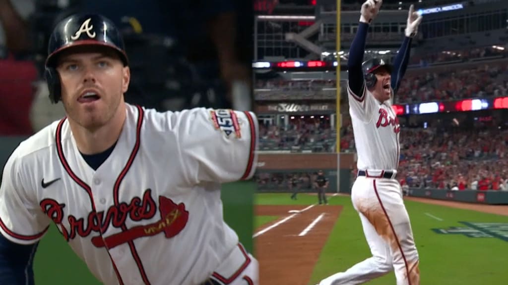 Atlanta Braves' Freddie Freeman reacts as he runs the third base line with  mascot Blooper cheering during his grand slam home run in the sixth inning  of a baseball game against the