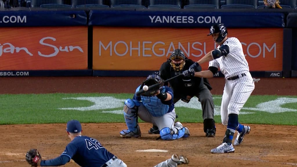 New York Yankees' Giancarlo Stanton watches his two-run home run