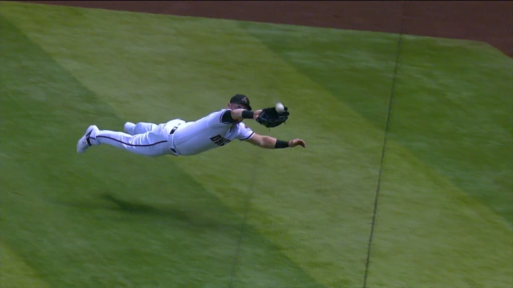 Texas Rangers left fielder Kole Calhoun makes a diving catch on a