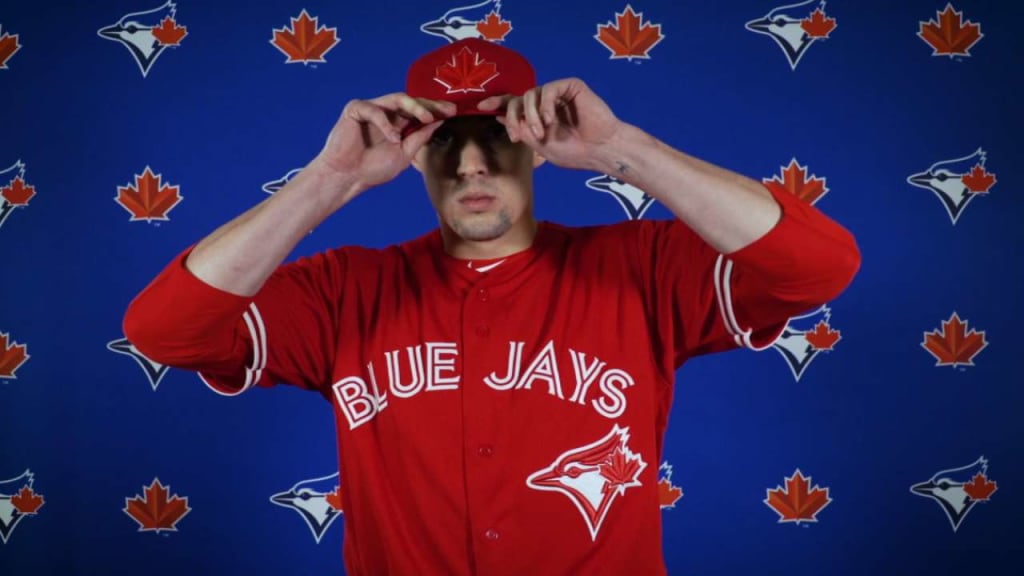 Male vendor in Red Blue Jays Jersey on Canada Day weekend selling Toronto  Blue Jays hats and jerseys outside Rogers Centre Stock Photo - Alamy