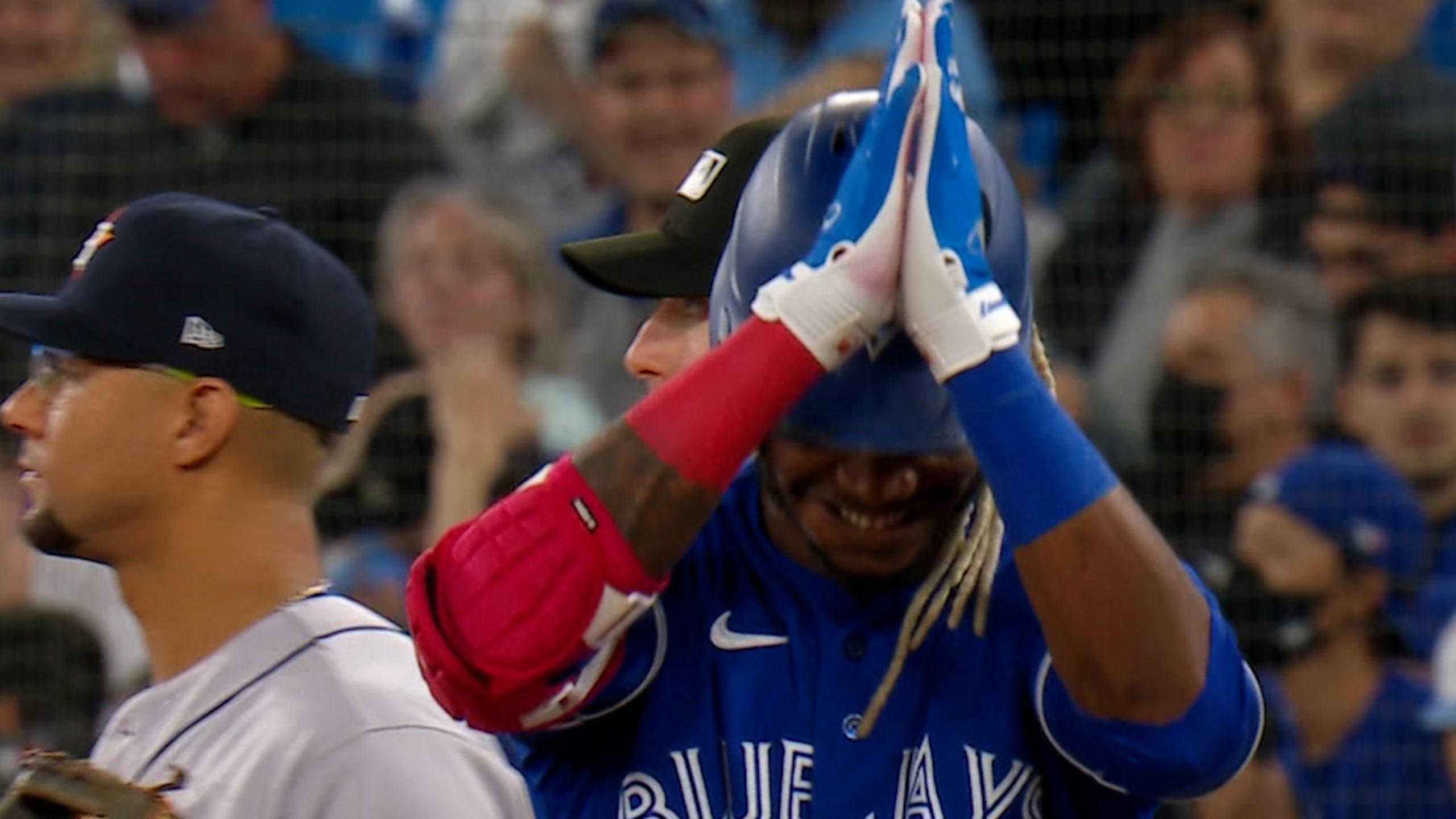 Toronto Blue Jays' Randal Grichuk reacts towards the Houston Astros' dugout  during a video replay of Grichuk being called safe at first during the  eighth inning of a baseball game against the