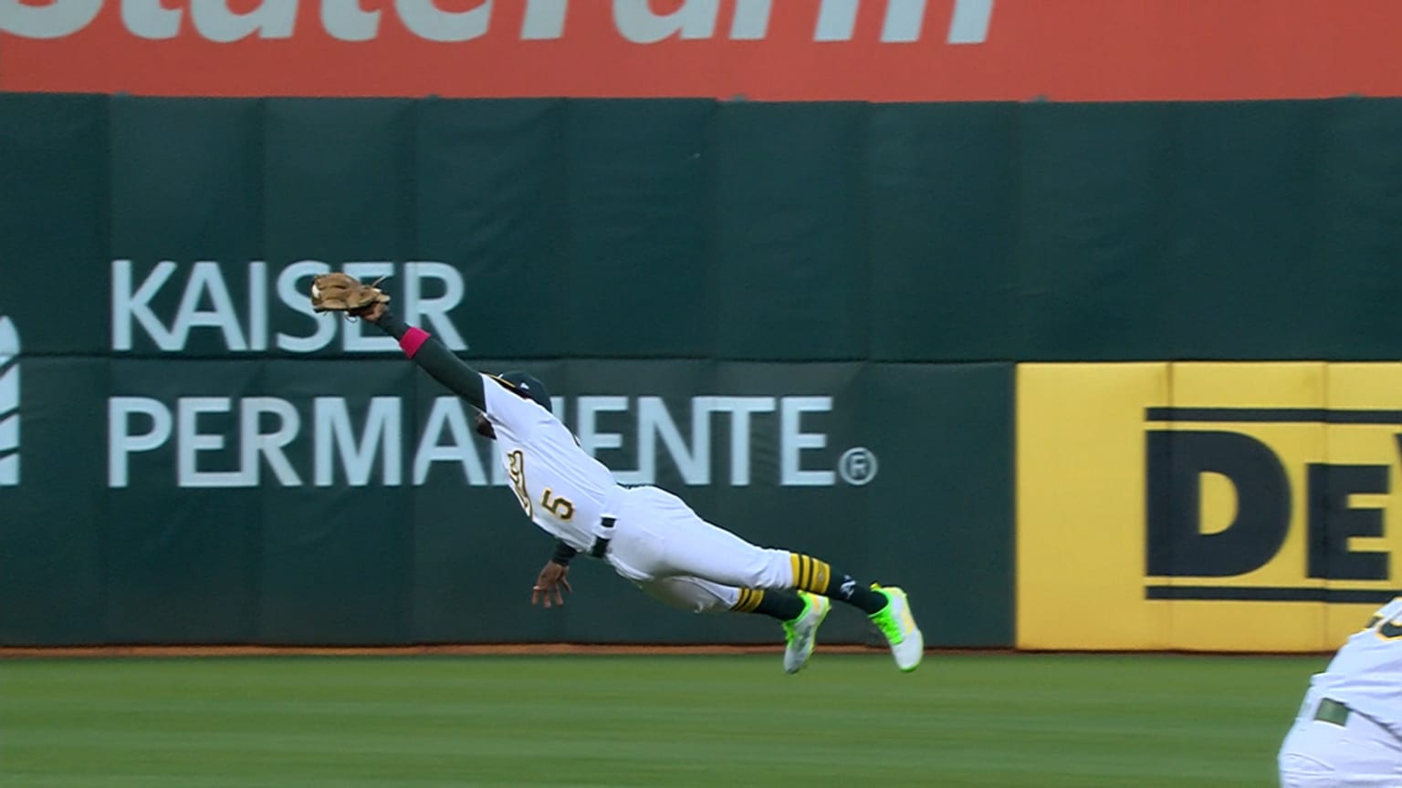 CLEVELAND, OH - JUNE 20: Oakland Athletics second baseman Tony Kemp (5)  makes a diving catch during the eighth inning of the Major League Baseball  game between the Oakland Athletics and Cleveland