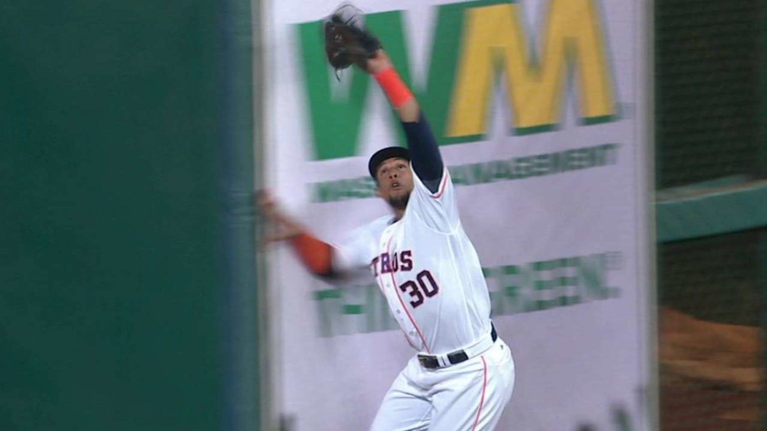 Carlos Gomez of the Milwaukee Brewers makes a catch at the wall