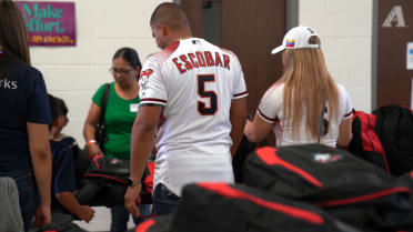 Escobar hands out school supplies