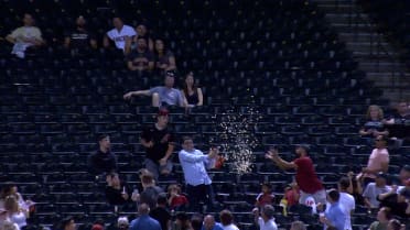 Fan catches foul ball with popcorn bucket