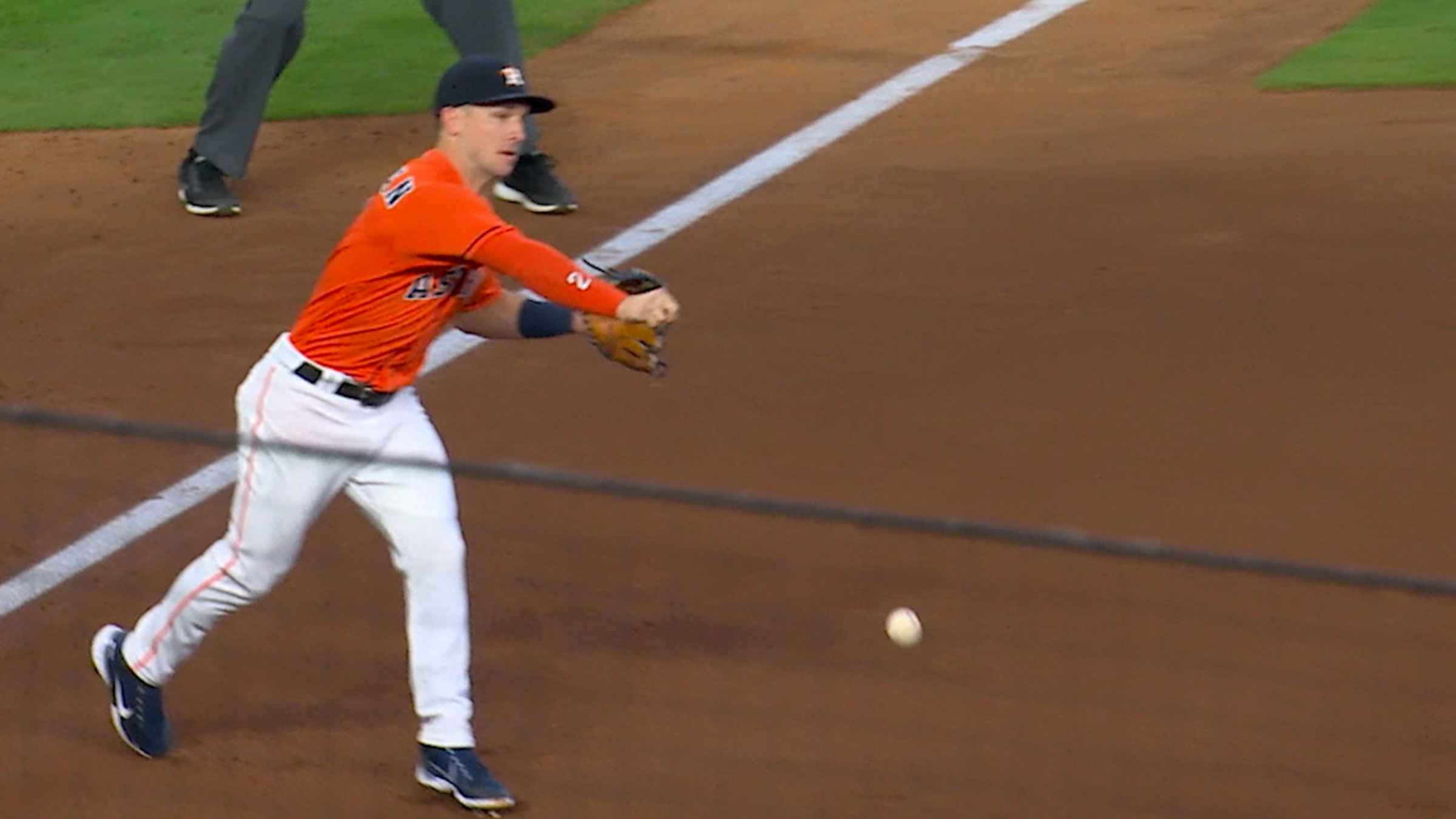 Alex Bregman catches the ball after it bounces off