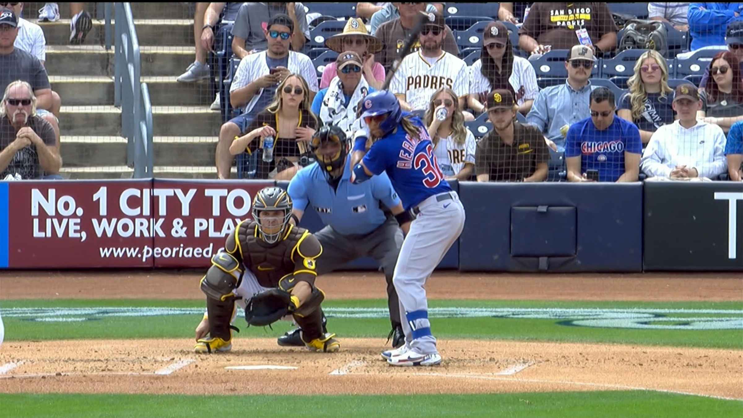 PEORIA, AZ - MARCH 26: Chicago Cubs outfielder Michael Hermosillo (32)  slides into home plate during the MLB Spring Training baseball game between  the Chicago Cubs and the San Diego Padres on