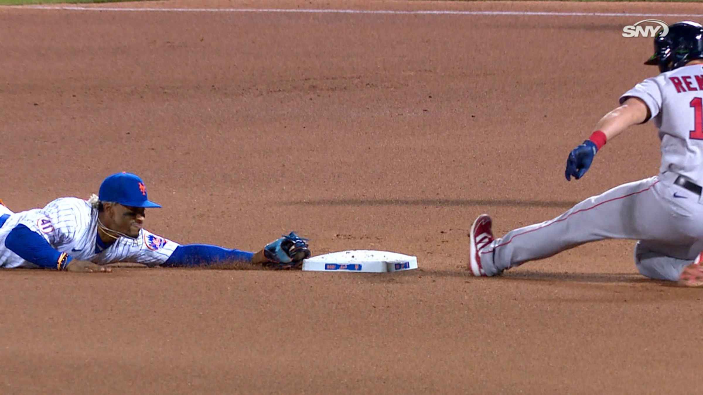 New York Mets Shortstop Francisco Lindor turns a double play on a