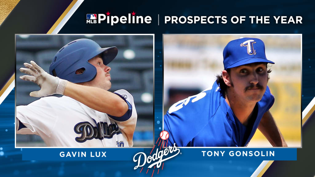 Los Angeles Dodgers' Gavin Lux, left, trips over Colorado Rockies