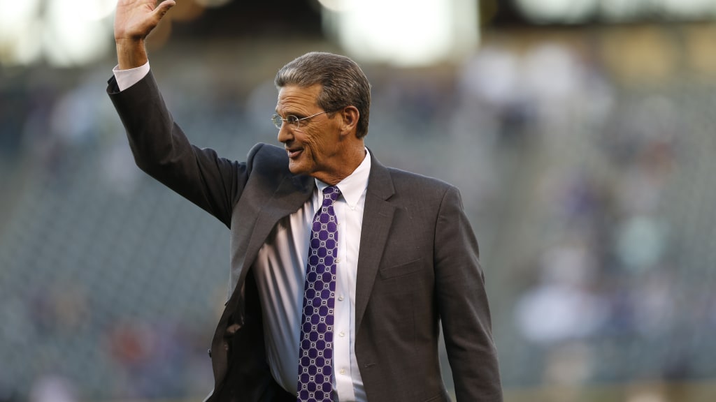 Colorado Rockies television color analyst George Frazier waves to crowd during a retirement ceremony before the Rockies host the Los Angeles Dodgers in the first inning of a baseball game Friday, Sept. 25, 2015, in Denver. (AP Photo/David Zalubowski)