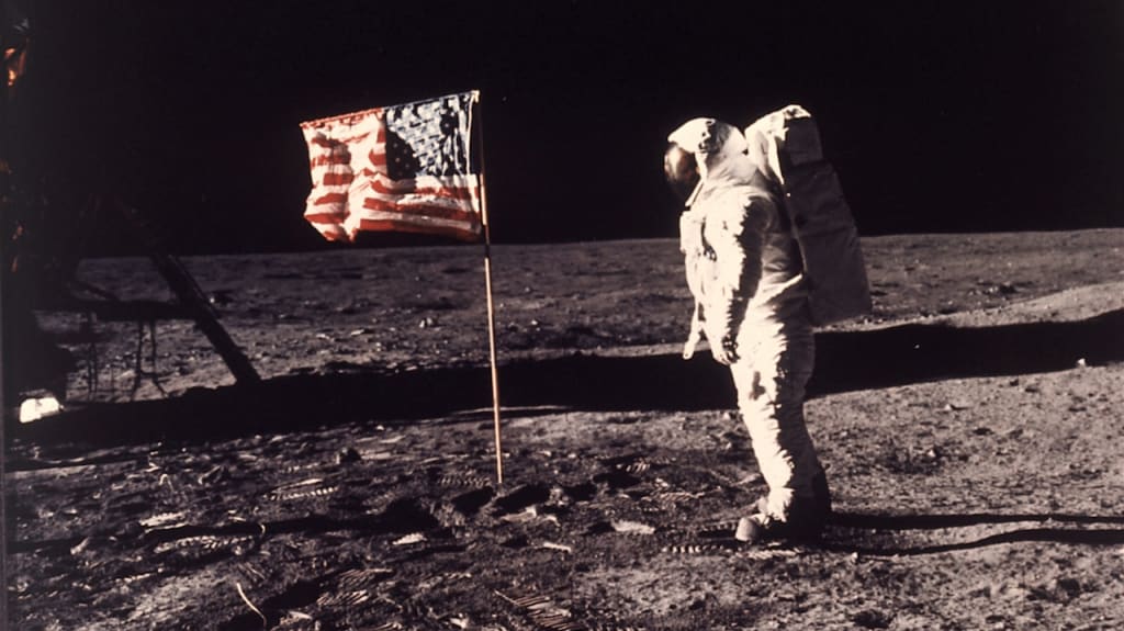 SPACE EXPLORATION, APOLLO 11 MISSION, FIRST MAN TO LAND ON MOON, WALK ON MOON, AMERICAN ASTRONAUT WITH U.S. FLAG, SPACE SUIT, LUNAR SURFACE, FOOTPRINTS, CENTURY SHOWCASE
