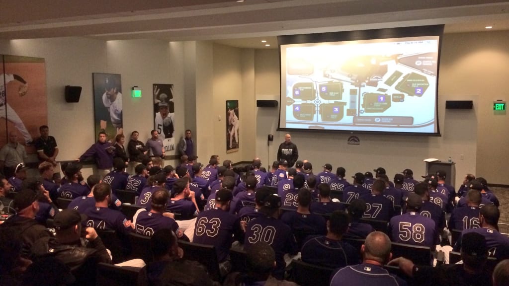 Rockies players and coaches gather for a team meeting before the club's workout. (Rockies)