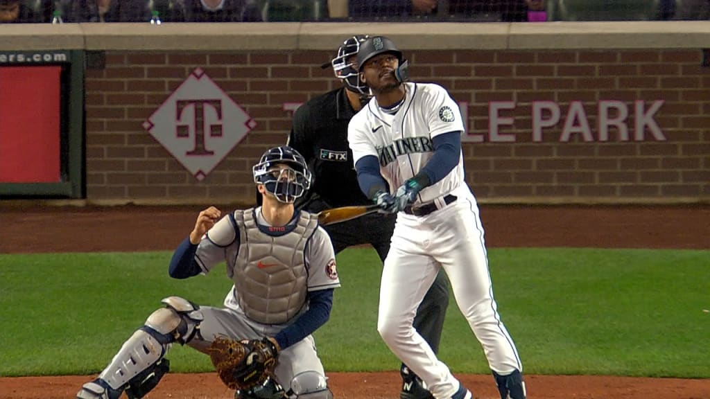 Seattle Mariners' Kyle Lewis (1) is greeted at the dugout by Taylor  Trammell, right, after Lewis hit a solo home run against the Houston Astros  during the second inning of a baseball