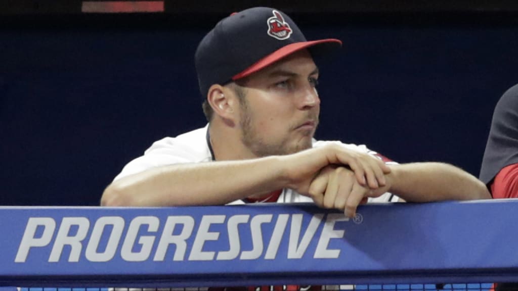 Cleveland Indians starting pitcher Trevor Bauer watches from the dugout during the ninth inning of the team's baseball game against the Cincinnati Reds, Tuesday, July 10, 2018, in Cleveland. The Reds won 7-4. (AP Photo/Tony Dejak)